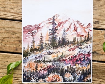 Puede incluir: Pintura acuarela de una cordillera con un pico nevado, rodeada de un bosque de árboles de hoja perenne y un campo de flores silvestres en tonos de rosa, morado y naranja.