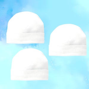 May include: Three white cotton beanie hats on a blue watercolor background.