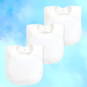 May include: Three white cotton baby bibs with a snap closure. The bibs are arranged in a stack, with the top bib slightly overlapping the bib below it.