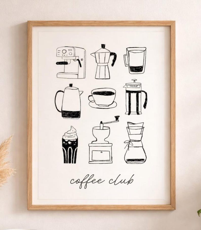 May include: A framed print featuring black and white illustrations of coffee-making equipment, including an espresso machine, a moka pot, a French press, and a coffee grinder. The words "coffee club" are written in cursive at the bottom.