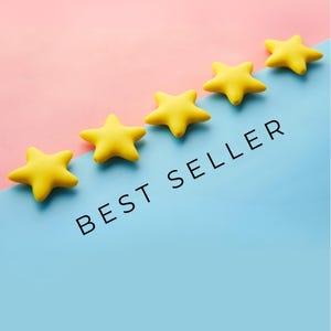 May include: Five yellow star-shaped objects arranged diagonally on a two-tone background. The background is split diagonally, with pink on top and blue on the bottom. The words "BEST SELLER" are printed in black.