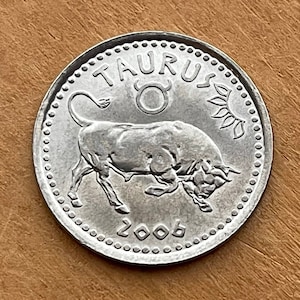 May include: Silver coin with a bull and the word "TAURUS" around the edge. The year "2006" is printed below the bull.