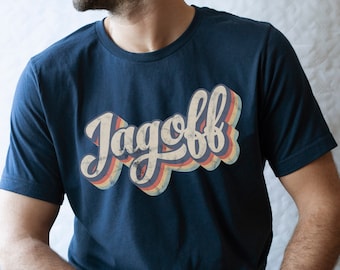 May include: A navy blue t-shirt with a retro-style graphic that says "Jagoff" in a multi-colored font.