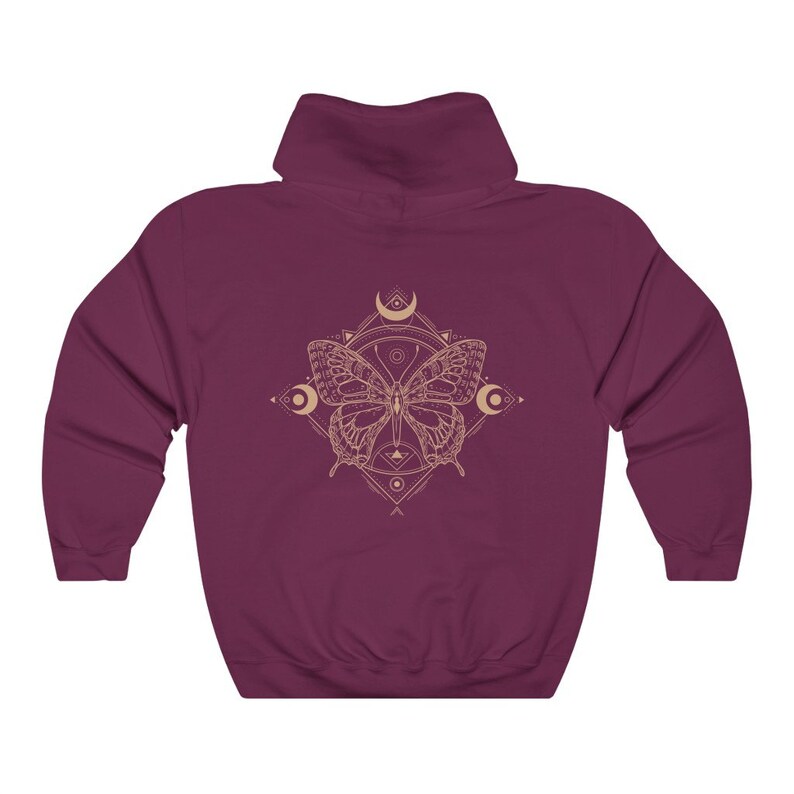 May include: Burgundy hooded sweatshirt with a graphic of a butterfly inside a geometric design with moons and stars.