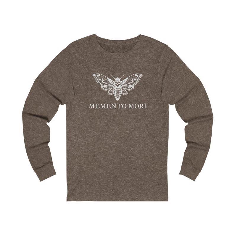 May include: A brown long-sleeved shirt with a white moth graphic and the text "MEMENTO MORI" printed on the front.