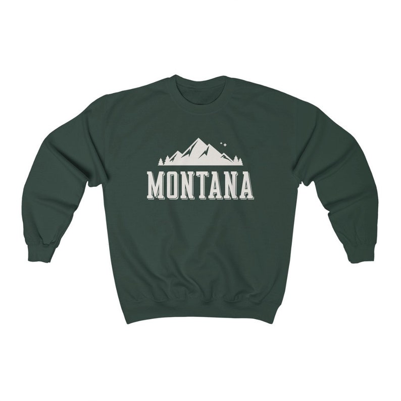 May include: A dark green sweatshirt with a white mountain graphic and the text "MONTANA" printed on the front.