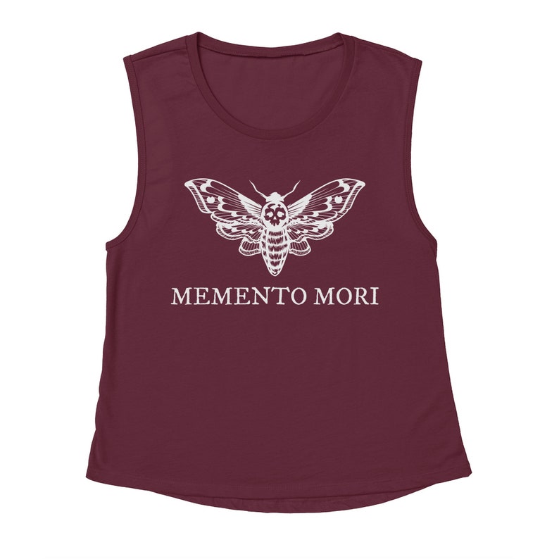 May include: A maroon sleeveless muscle tank top with a white skull moth graphic and the text "MEMENTO MORI" printed on the front.