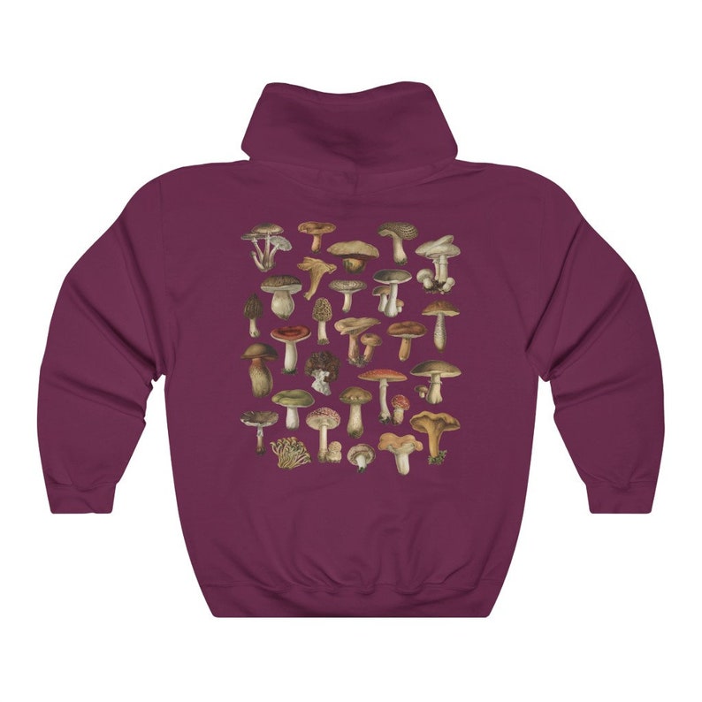 May include: Burgundy hoodie featuring a detailed illustration of various mushrooms in shades of brown, green, and red. The design is centered on the back of the hooded sweatshirt. The hoodie has a drawstring hood and a kangaroo pocket.