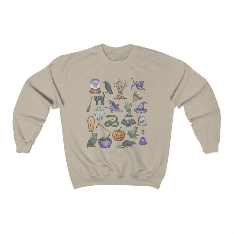 May include: A beige sweatshirt with a colorful print of various Halloween-themed icons, including a ghost, a cauldron, a bat, a skull, a snake, a witch's hat, a raven, a cat, a pumpkin, a tree, a frog, a rat, a coffin, a broom, a magic wand, and a potion bottle.