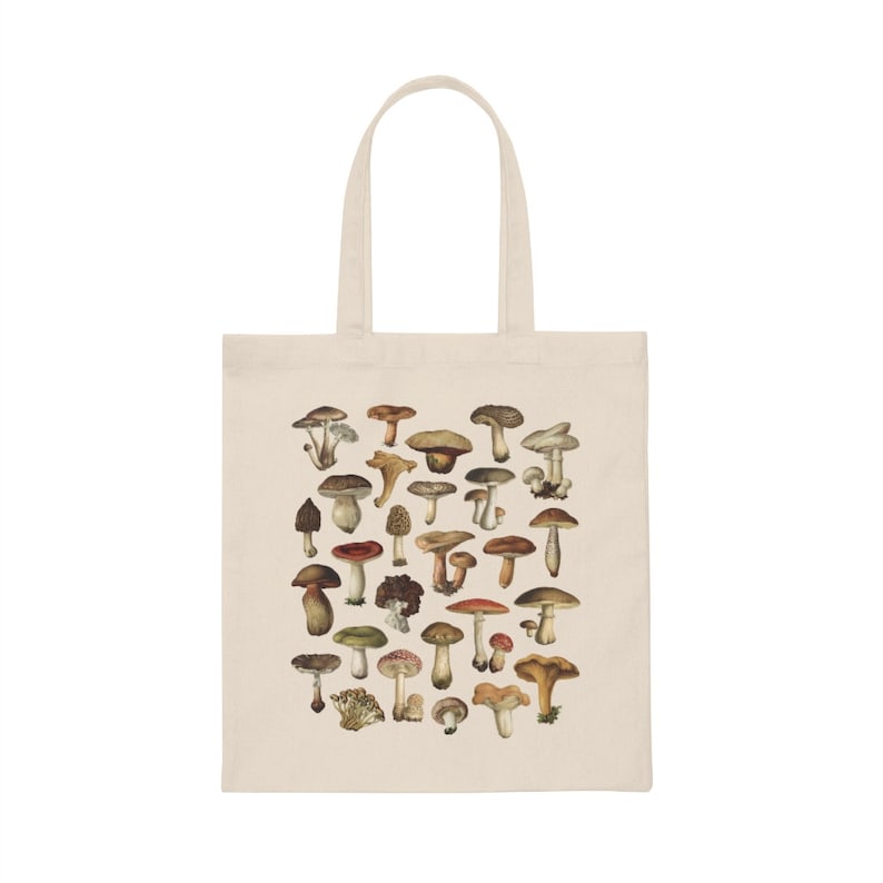 May include: A beige tote bag with a white print of various types of mushrooms. The mushrooms are illustrated in a vintage style with different colors and shapes.