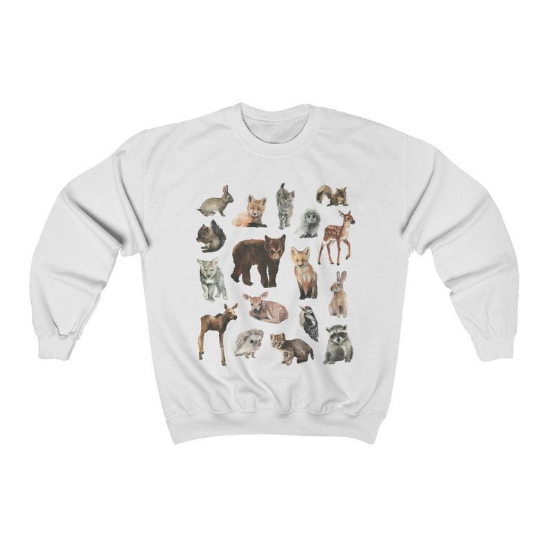 May include: White sweatshirt featuring a colourful print of various woodland animals, including a bear, fox, deer, rabbit, squirrel and owl.