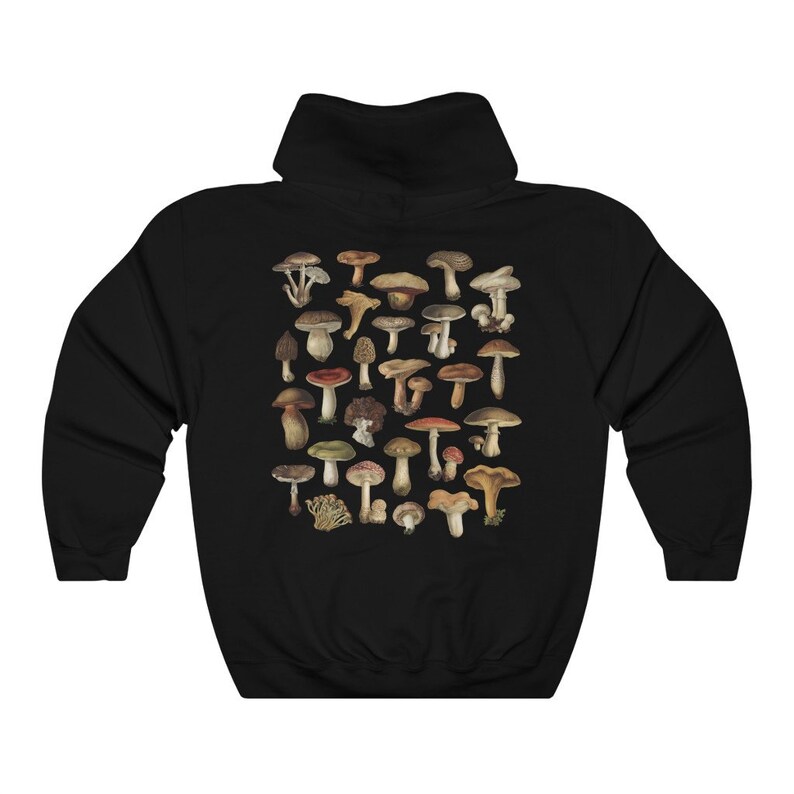 May include: Black hooded sweatshirt featuring a detailed illustration of various mushrooms in shades of brown, tan, red, and green. The design is centered on the back of the sweatshirt. The sweatshirt has a drawstring hood and a kangaroo pocket.