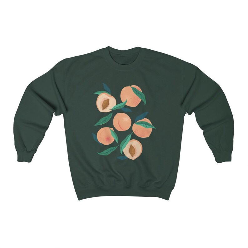 May include: A dark green sweatshirt with a graphic print of peaches and leaves. The peaches are a light peach color and the leaves are a light green color.