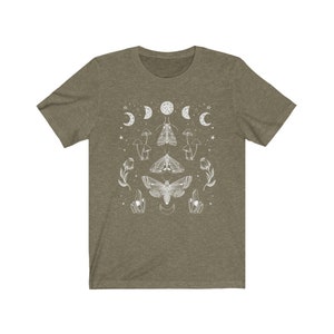 May include: A green t-shirt with a white design of moths, mushrooms, and moons. The design is symmetrical and features a large moth in the center.