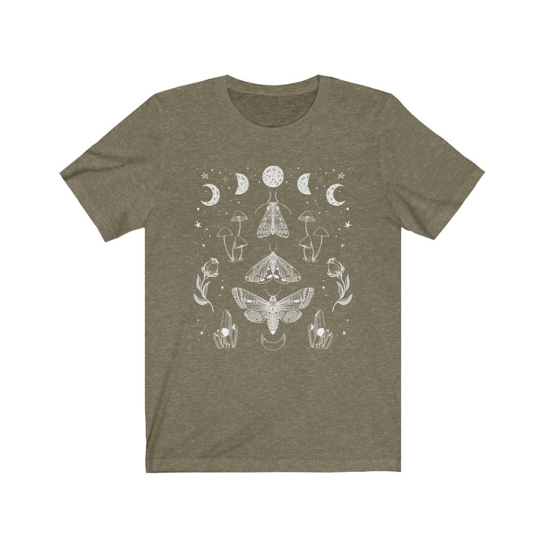 May include: A green t-shirt with a white design of moths, mushrooms, and moons. The design is symmetrical and features a large moth in the center.