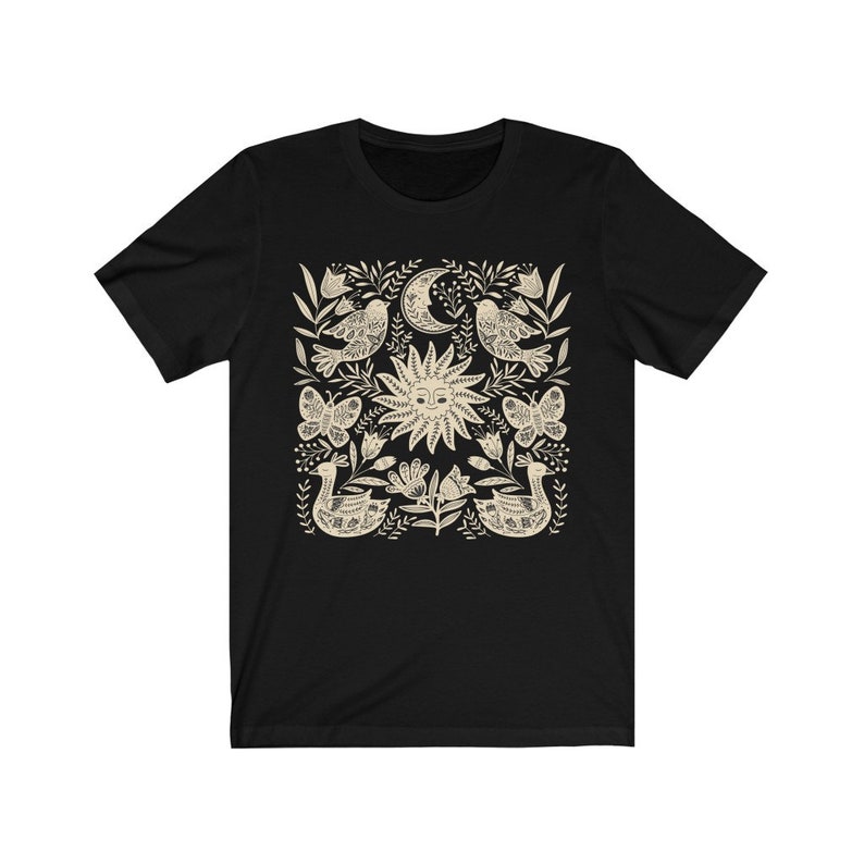 May include: Black t-shirt with a white sun, moon, birds, butterflies, and floral design.