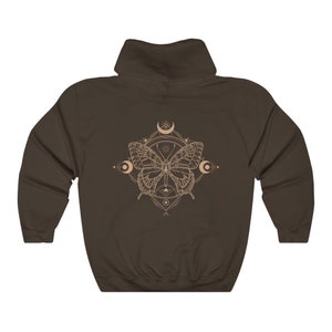 May include: A brown hooded sweatshirt with a graphic of a butterfly inside a geometric design with moons and stars.