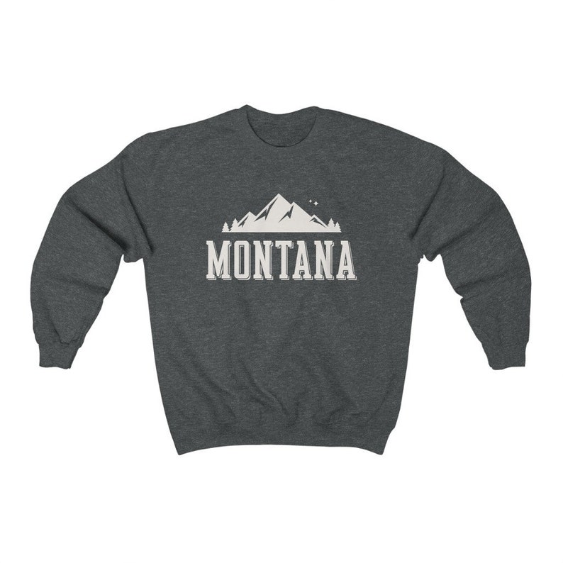 May include: A dark heather grey sweatshirt with a white mountain graphic and the text "MONTANA" printed on the front.