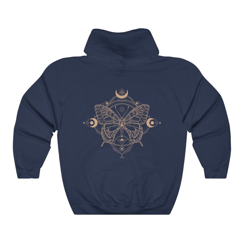 May include: Navy blue hooded sweatshirt with a graphic of a butterfly with geometric patterns and moons in a light brown color.