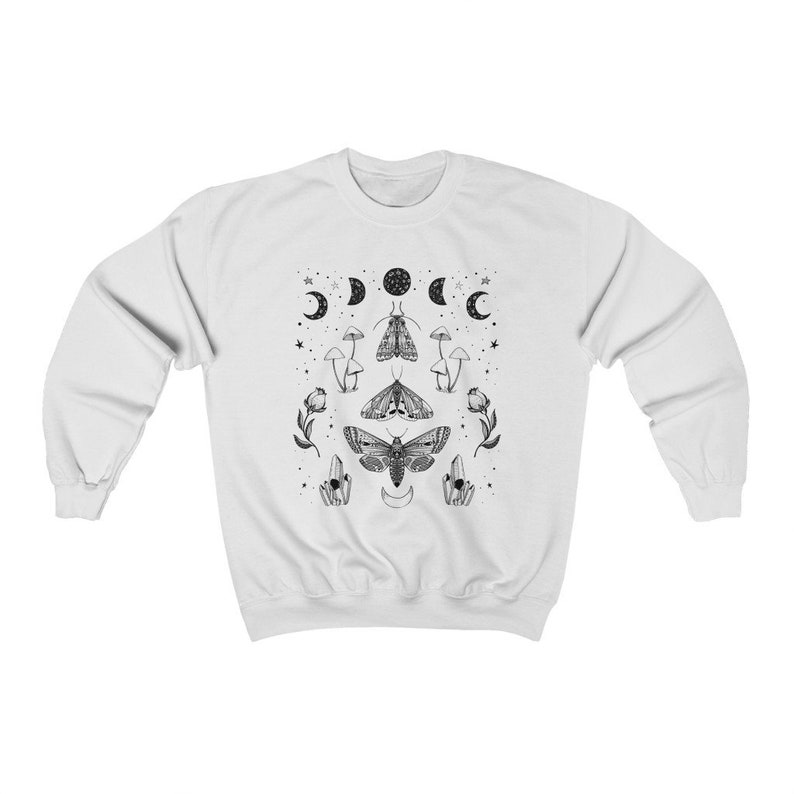 May include: White sweatshirt with a black and white graphic print of a moth, mushrooms, crystals, and moons.