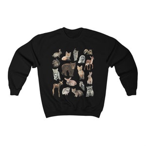 May include: Black sweatshirt featuring a colourful print of various baby animals, including a bear, fox, deer, raccoon and owl.