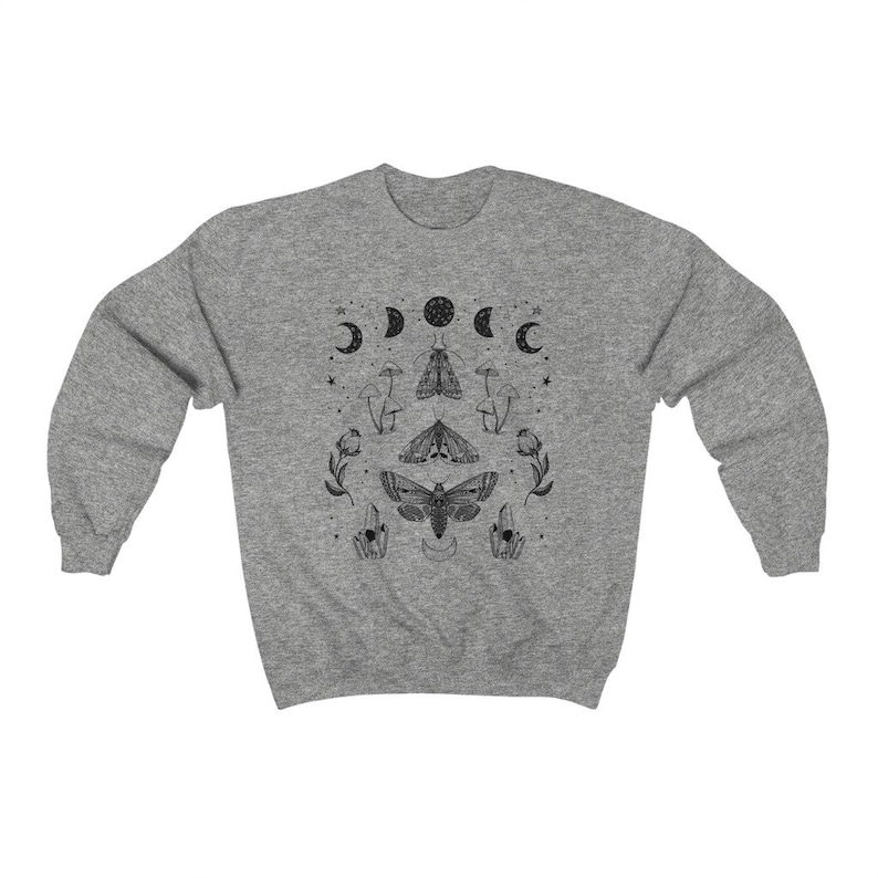 May include: A heather grey sweatshirt with a black and white graphic print of moths, mushrooms, and crescent moons. The graphic is centered on the front of the sweatshirt.