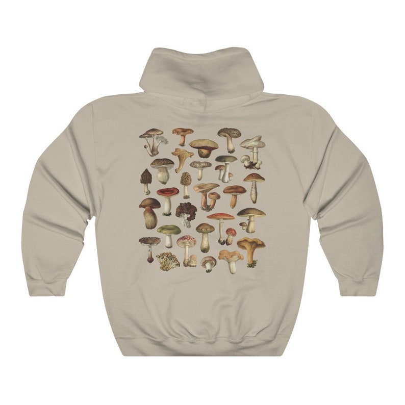 May include: A beige hoodie featuring a detailed illustration of various mushrooms in shades of brown, red, and green. The design is centered on the back of the hoodie, showcasing a variety of fungi species. The hoodie has a classic hooded design.