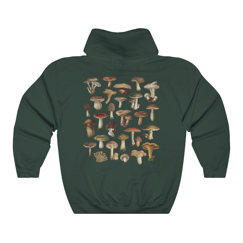 May include: Dark green hoodie featuring a collection of various mushroom illustrations in shades of brown, red, and beige. The mushrooms are arranged in a cluster on the back of the hoodie. The hoodie has a hood and long sleeves.