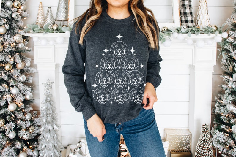 May include: A dark gray sweatshirt with a white design of a Christmas tree made up of dog faces. The tree is decorated with white stars.