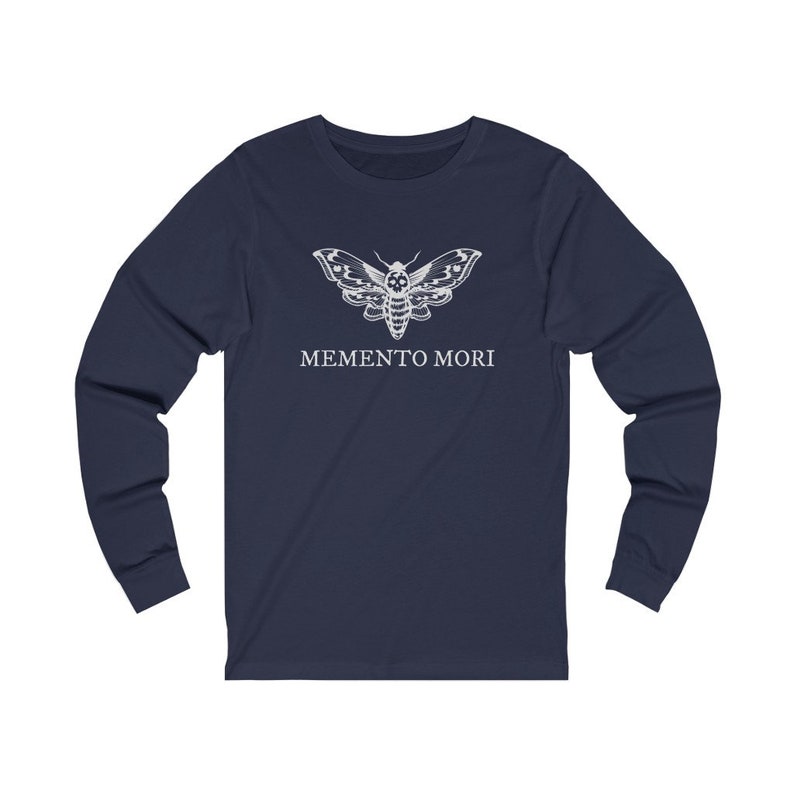 May include: Navy blue long-sleeved t-shirt with a white moth graphic and the text "MEMENTO MORI" printed on the front.