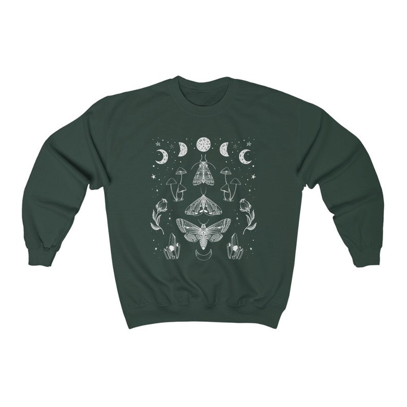 May include: A dark green sweatshirt with a white graphic design featuring moths, moons, mushrooms, and crystals.