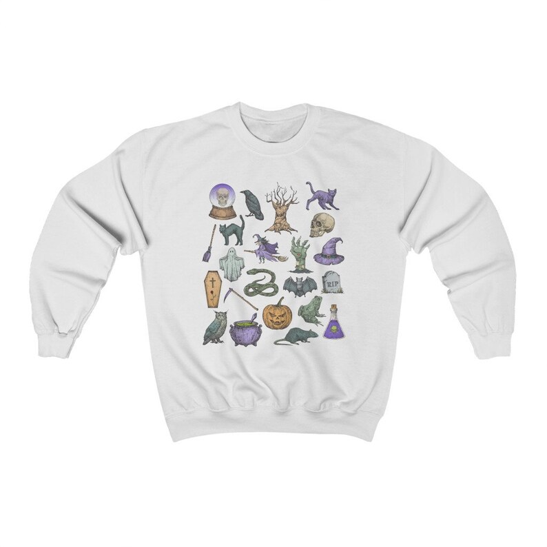 May include: White sweatshirt with a colorful print of various Halloween icons, including a ghost, a cat, a cauldron, a snake, a bat, a pumpkin, a skull, a witch, a crow, a tree, a coffin, a grave, a potion bottle, a broom, a hand, a frog, a rat, and a crystal ball.