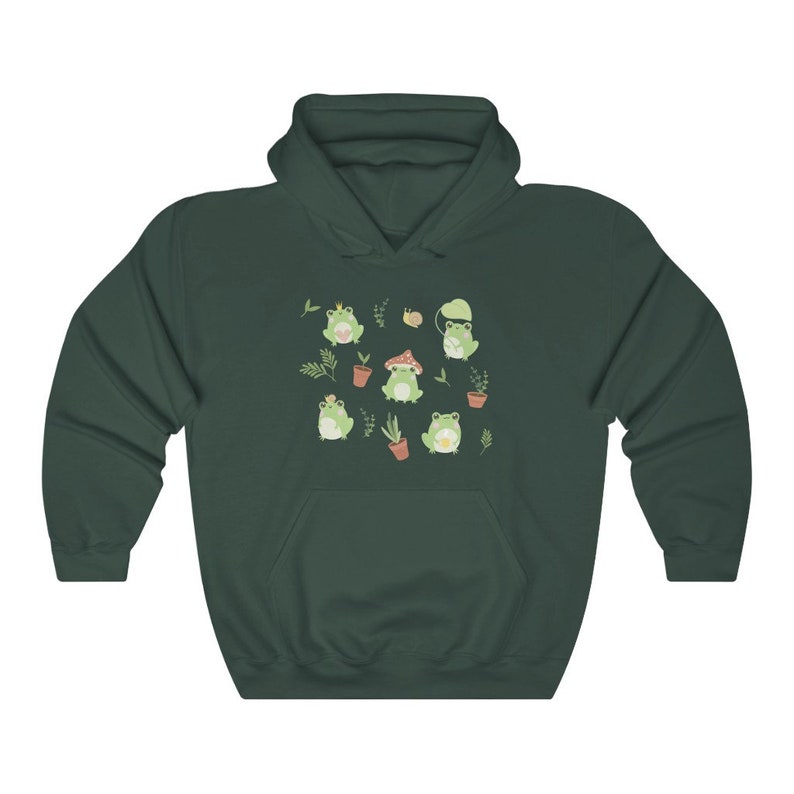 May include: A dark green hoodie with a pattern of frogs, mushrooms, and plants. The frogs are wearing crowns, hats, and holding flowers.