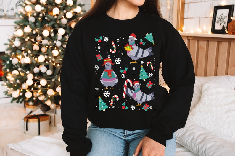 May include: Black Christmas jumper featuring a festive design of pigeons wearing Santa hats, candy canes and Christmas trees.