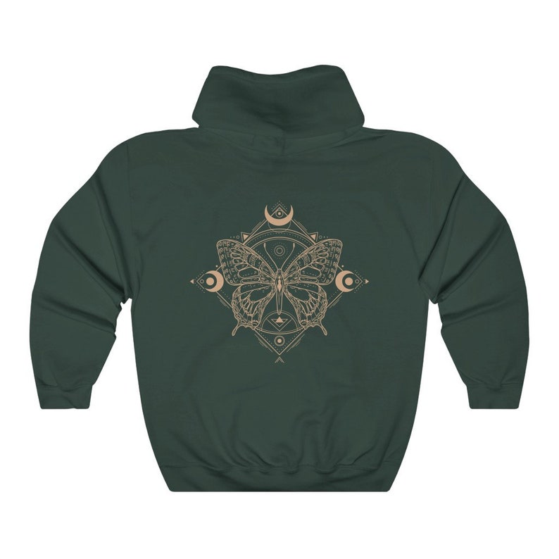 May include: A dark green hooded sweatshirt with a graphic print of a butterfly with geometric patterns and crescent moons in a beige color.