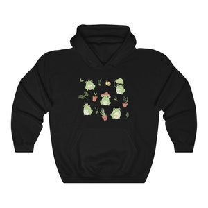 May include: Black hooded sweatshirt with a pattern of green frogs, mushrooms, and plants.