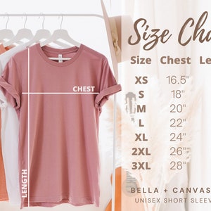 May include: Size chart for a unisex short sleeve tee shirt. The chart shows chest and length measurements in inches for sizes XS, S, M, L, XL, 2XL, and 3XL. The shirt is shown hanging on a rack.