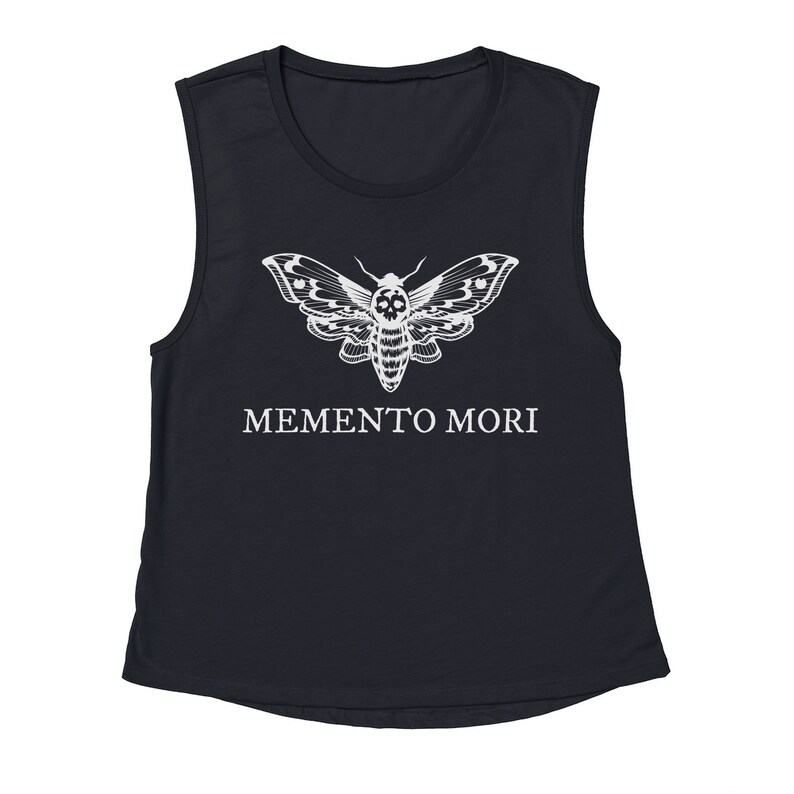 May include: A black sleeveless shirt with a white skull moth graphic and the text "MEMENTO MORI" printed on the front.