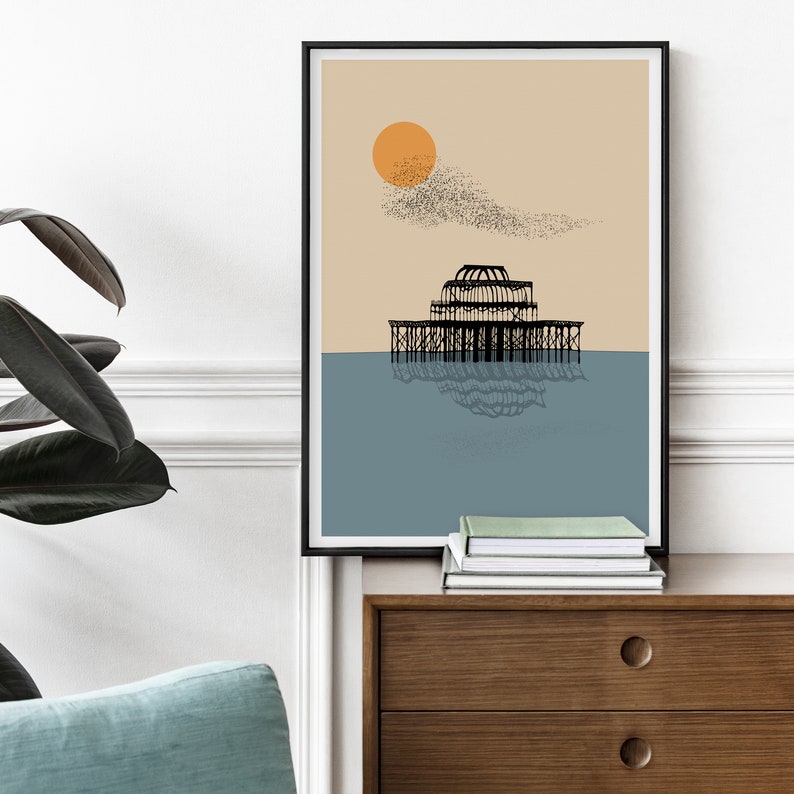 May include: A minimalist art print featuring a black silhouette of a pier with a reflection in the water. The background is a light beige with a large orange sun and a flock of birds flying overhead.