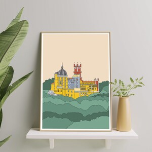 May include: A framed illustration of a yellow castle with red and blue accents, set against a background of green hills.