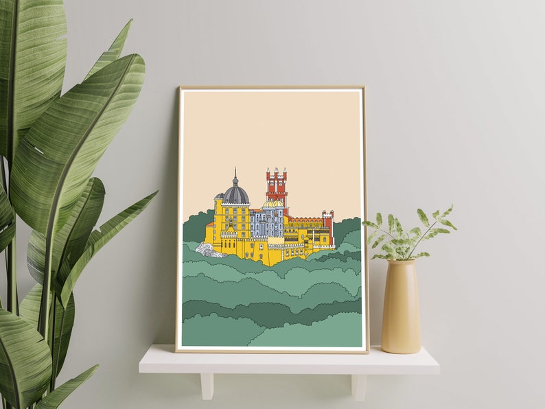 May include: A framed illustration of a yellow castle with red and blue accents, set against a background of green hills.