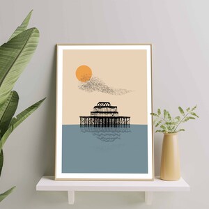 May include: A minimalist art print featuring a black silhouette of a pier with a reflection in the water. The background is a light peach color with a large orange sun and a flock of birds flying overhead.