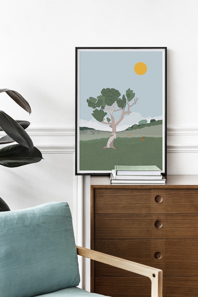 May include: A framed illustration of a stylized tree with a yellow sun in a blue sky. The tree is brown with green leaves and is set against a green grassy field with hills in the background.