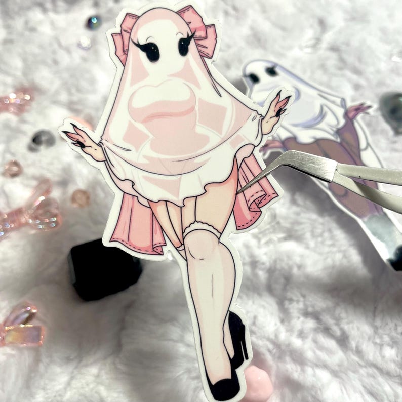 May include: A pink and white ghost sticker with a white sheet and a pink dress. The ghost has black eyes and eyelashes and is wearing a pink bow. The sticker is on a white background.
