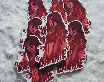 May include: Multiple red and white stickers featuring a woman with long red hair and the text "Carrie" in a bold, white font.