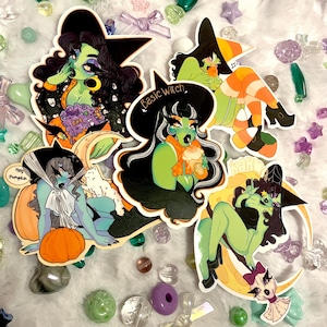 May include: Four colorful witch stickers with different poses and accessories. The stickers feature green skin, black hats, and various Halloween-themed details. The text on the stickers reads "Basic Witch" and "Hey Pumpkin".