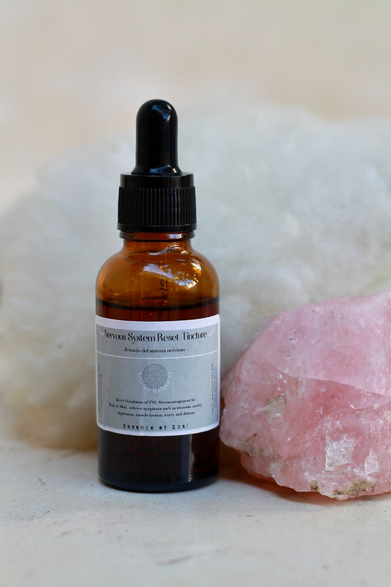 May include: A brown glass bottle with a black dropper top. The bottle is labeled "Nervous System Reset Tincture -  Revisi&oacute;n del sistema nervioso -  A direct modulation of PNS Neurotransmitter for  N.A.D. that relieves symptoms such as insomnia, anxiety, depression, mood imbalance, worry and stress. Essence of Zasi"