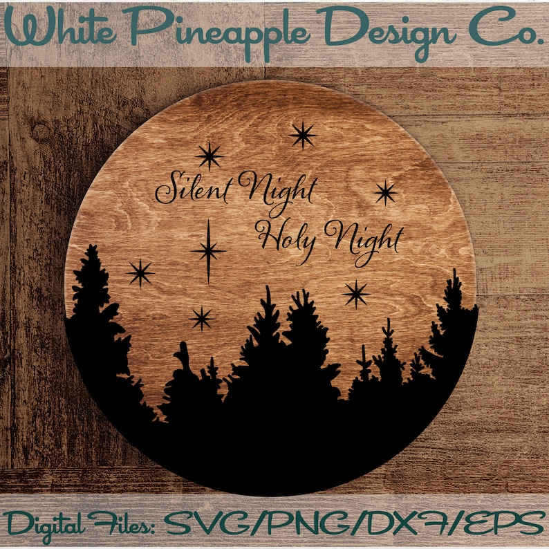 May include: A round wooden sign with a black silhouette of a forest and the text "Silent Night Holy Night" in a cursive font.