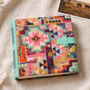 May include: A set of three ceramic nesting bowls in graduating sizes. The bowls feature a speckled, matte finish in shades of cream, beige, and brown. The largest bowl measures approximately 8 inches in diameter.