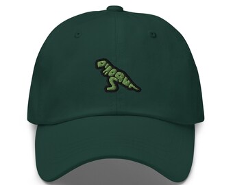 May include: A dark green baseball cap with a curved brim. The cap features an embroidered green dinosaur design with the word "Dino" incorporated into the dinosaur's body. The cap is made of a soft fabric and has an adjustable strap.